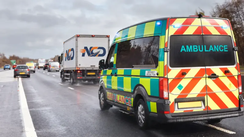 National Couriers Direct lorry on the road beside an ambulance, on an urgent medical delivery