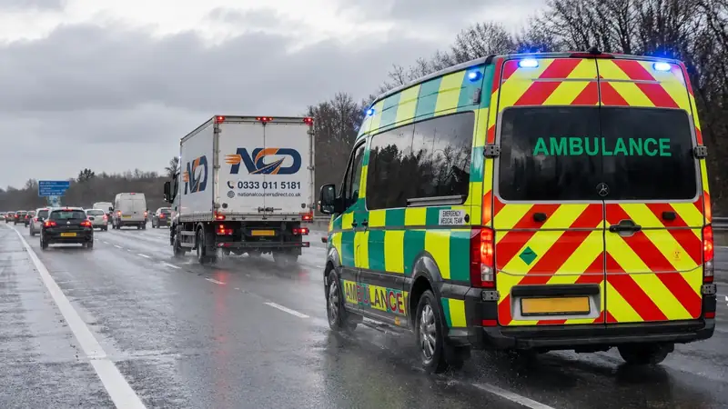 National Couriers Direct lorry on an urgent medical delivery beside an ambulance