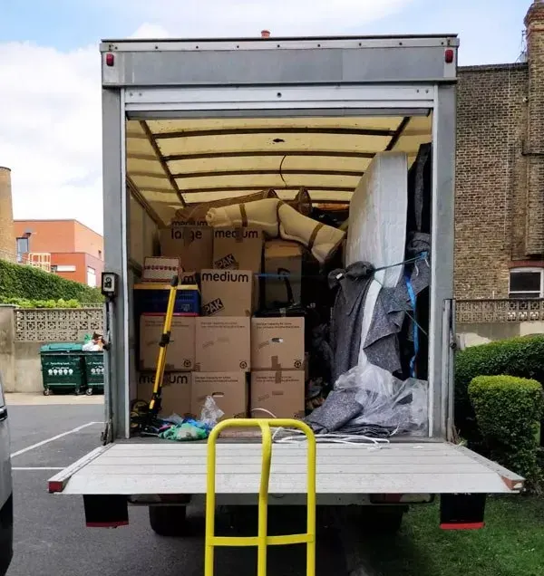 Luton van with its tail lift down, loaded with boxed goods